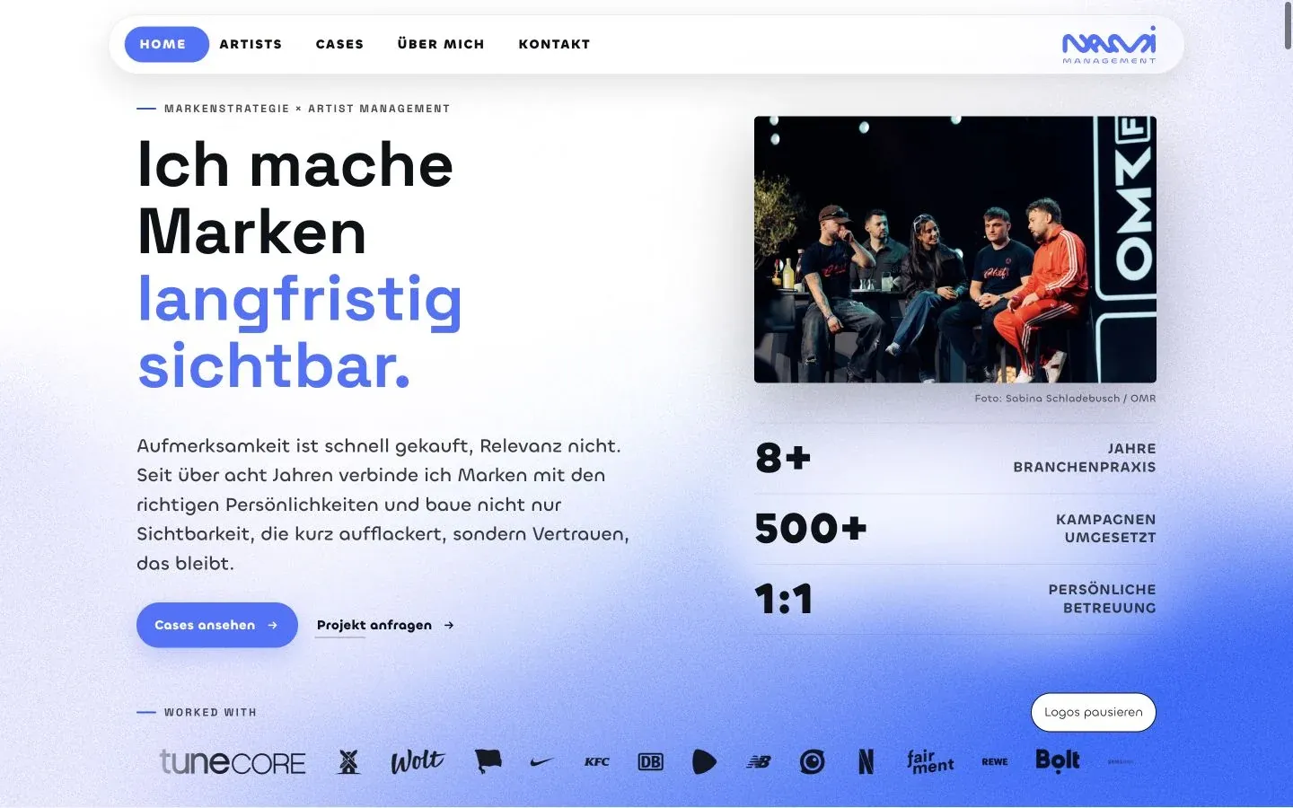 NAMI Management homepage with blue gradients, bold typography, and a panel photograph.